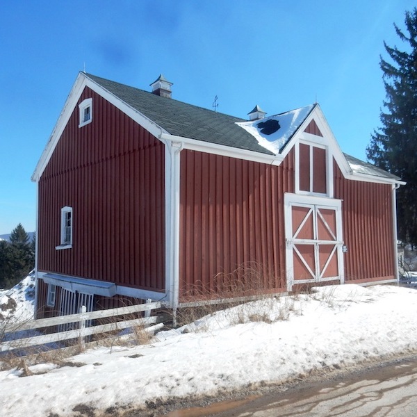 Two-story red barn in winter