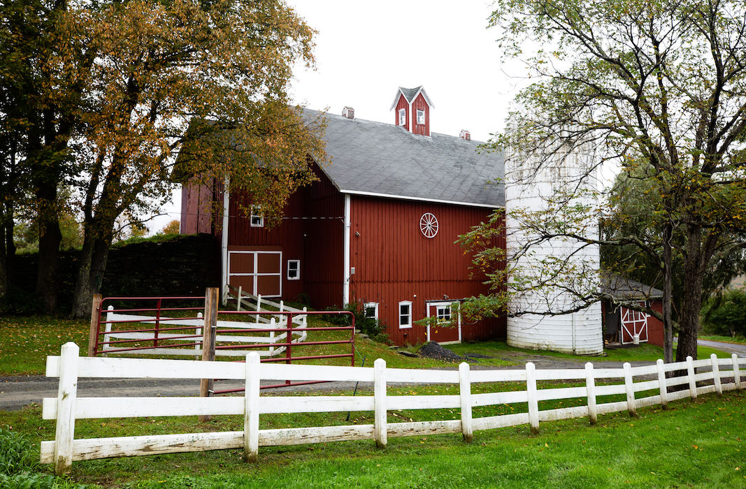 Red barn with white silo