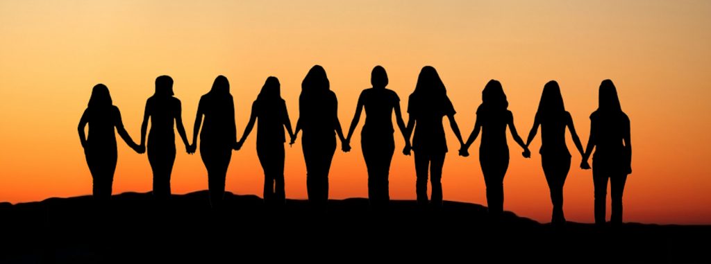 Group of people holding hands in silhouette